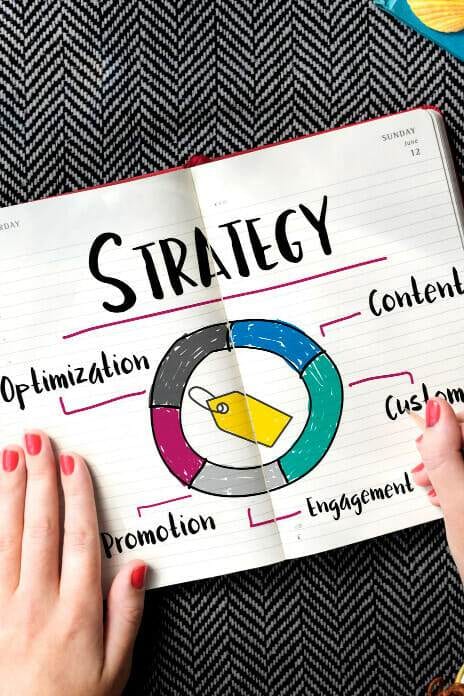 a person holding a note book on strategy.