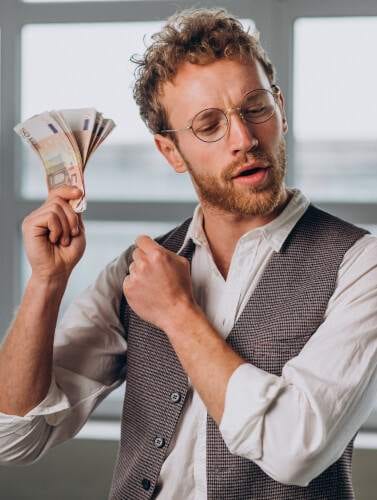 a man holding money in his hand, earned from a passive income idea.