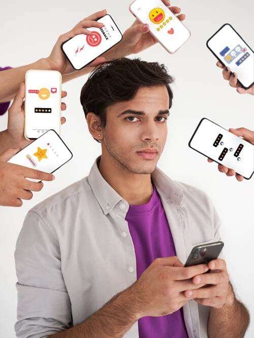 young man looking puzzled, holding a smartphone with various hands displaying phones with different app screens around him, representing social media authenticity.