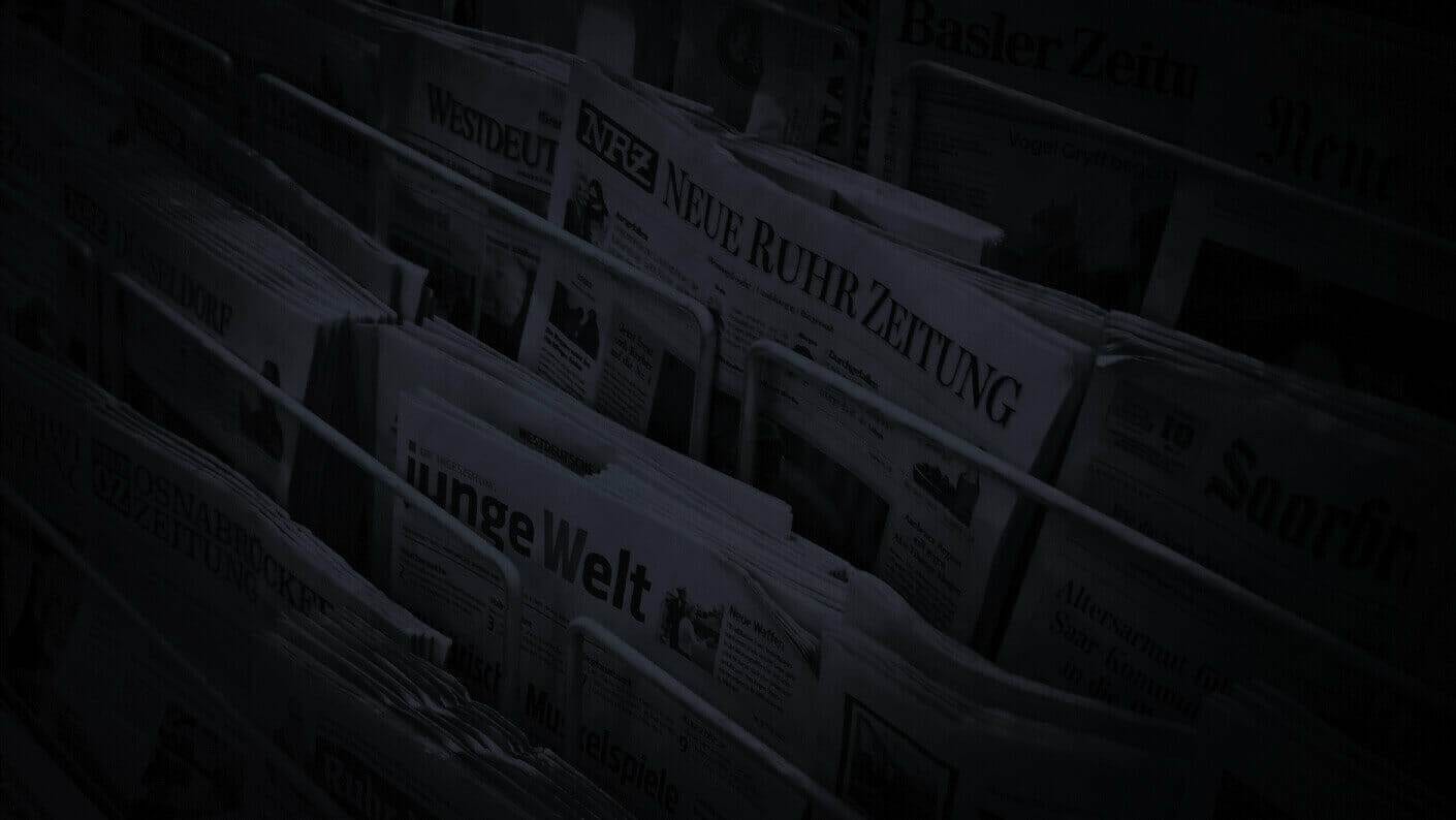 a rack of newspapers showcasing the most recent online marketing news.