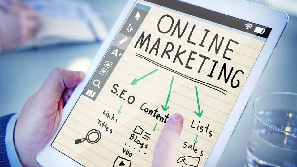 A person holding a tablet with online marketing written on it, implementing 4 Practical Affiliate Marketing Tips.