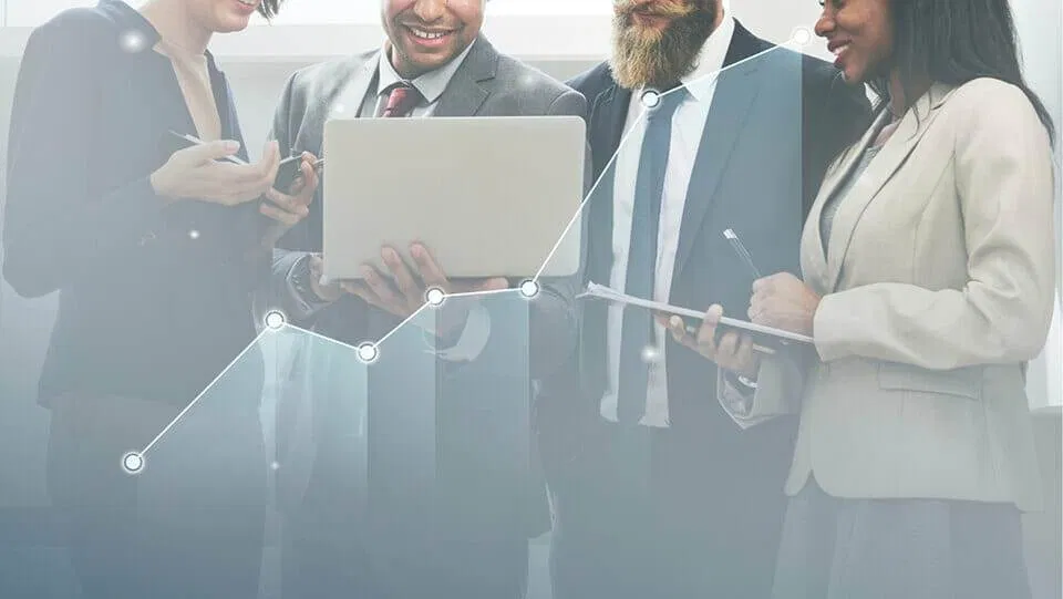 A group of business people looking at a graph, analyzing page tweaks that increase conversions.