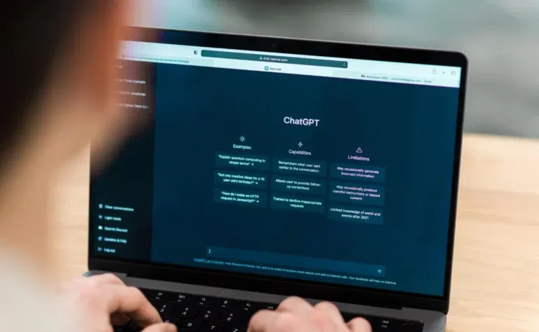 a person is using a laptop displaying the chatgpt interface, with sections for examples, capabilities, and limitations on the screen. hidden chatgpt strategies that marketers often overlook can be discerned throughout these sections.