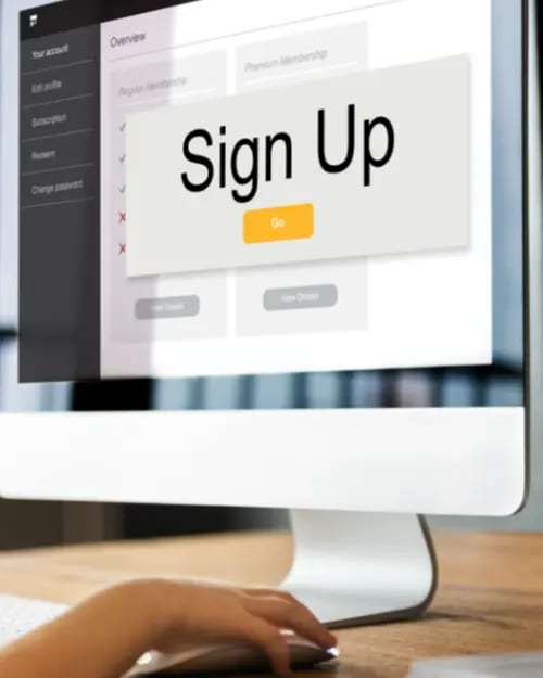 a person browses a website on a computer monitor displaying a large "sign up" button with additional membership options in the background, exploring strategies for sustainable income through various continuity programs.